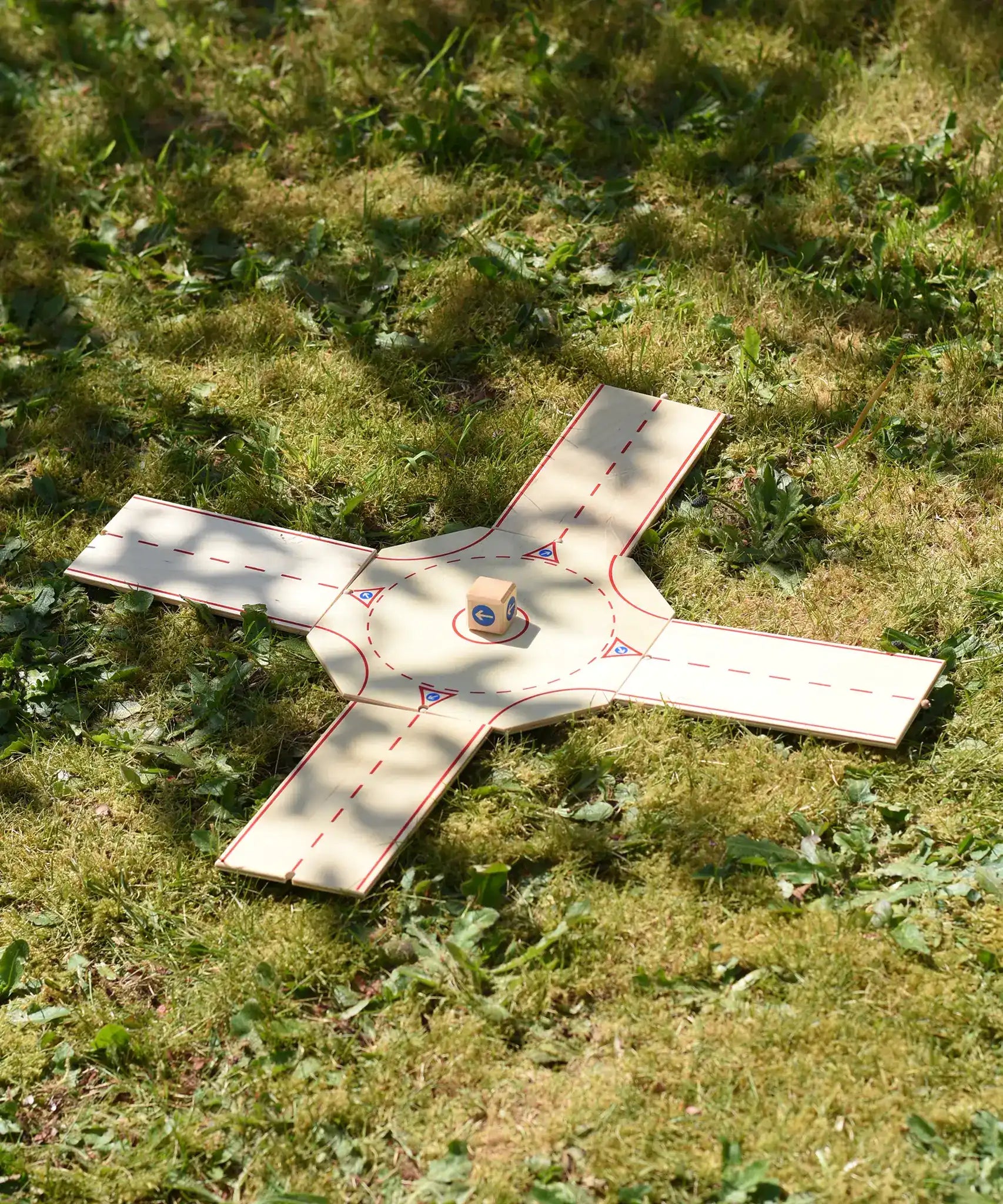 Beck wooden roundabout junction set set up and placed on grass. 