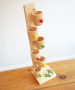 The Beck Toys Beech Wood Roller Cup Marble Run placed on a wooden surface.