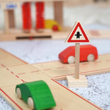 A Beck wooden junction traffic sign standing near a road set with vehicles on top 