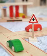 A Beck wooden junction traffic sign standing near a road set with vehicles on top 