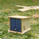 Beck wooden double garage toy placed on grass outdoors.
