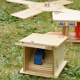 Beck wooden double garage toy placed in a small world set up with a boy car placed on the top level.