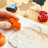 Close up of hand holding a bee crayative halloween themed crayon