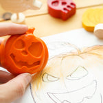 Close up of hand colouring in a pumpkin drawing with the bee crayative large pumpkin coloured crayon