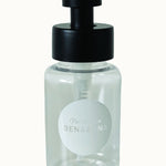 Ben & Anna Shower Gel Flakes Dispenser with black lid, on a cream background