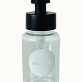 Ben & Anna Shower Gel Flakes Dispenser with black lid, on a cream background