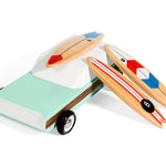Three unique magnetic wooden surfboard toys on the beach.