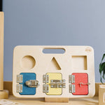 Big Future Toys wooden latch board on its stand on a wooden table next to an abacus in front of a grey wall