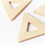 Close up of 3 triangular pieces from the Big Future eco-friendly wooden earth tiles set on a white background