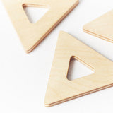 Close up of 3 triangular pieces from the Big Future eco-friendly wooden earth tiles set on a white background