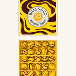 Billes & Co marbles in a banana twist design. Features 25 yellow and brown glass marbles and a matching decorative box. 