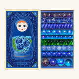 Opened decorated box of Billes & Co Yelena Matriochka doll inspired marbles in shades of blues and greens
