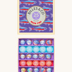 Billes & Co marbles in a neon fish inspired design. Features 25 pearlescent marbles with a mixture of glow in the dark glass marbles and a box with neon fish