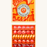 Billes & Co marbles in a orange wave inspired design. Features 29 orange and white glass marbles with a mixture of textured and flat marbles. Comes in a matching decorative box. 