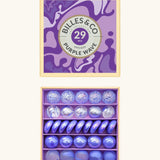 Billes & Co marbles in a purple wave inspired design showing 29 glass marbles and comes in a matching decorative box. 