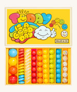 Billes & Co marbles in today's a good day inspired set. Features 67 rainbow coloured  glass marbles with a mixture of textured and flat marbles. Comes in a yellow coloured box with a playful design of a cloud and rainbow. 