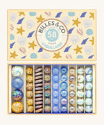 Billes & Co Seashells Glass Marbles Box - 58 Pack. Includes flat, large and small marbles which are smooth and some are textured with a seashell and beach design and colour