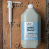 A Bio-D 5L screw on pump lying next to a Bio-D 5L cleansing handwash bottle,  both available at Babipur. This pump can be used on any 5L Bio-D liquid for easy refilling 