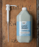 A Bio-D 5L screw on pump lying next to a Bio-D 5L cleansing handwash bottle,  both available at Babipur. This pump can be used on any 5L Bio-D liquid for easy refilling 