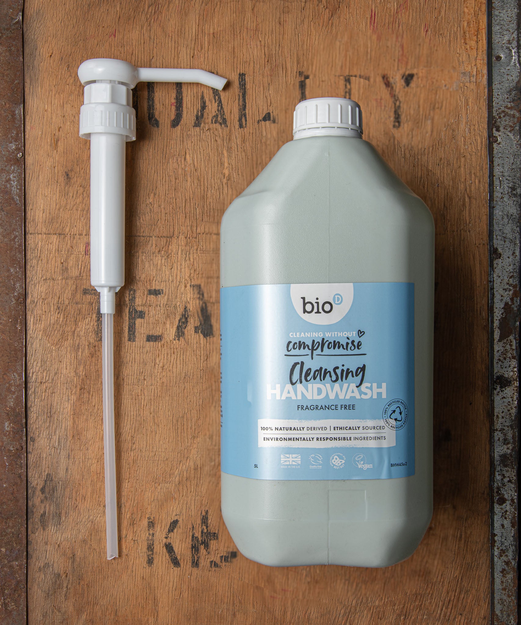 A Bio-D 5L screw on pump lying next to a Bio-D 5L cleansing handwash bottle,  both available at Babipur. This pump can be used on any 5L Bio-D liquid for easy refilling 