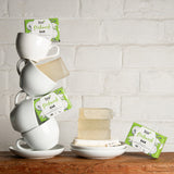 A stack of white mugs with bars of the Bio-D dish washing soap inside them. These dish soap bars are available at Babipur.