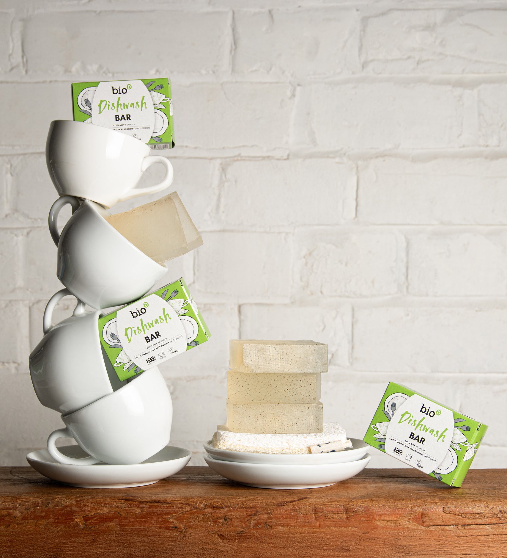A stack of white mugs with bars of the Bio-D dish washing soap inside them. These dish soap bars are available at Babipur.