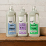 A group of Bio-D fabric conditioner standing on a wooden surface, image showing the fragrance free, lavender and juniper bottles. These are available at Babipur.
