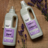 A 1L bottle of Bio-D lavender fabric conditioner and laundry liquid on a piece of hessian with sprigs of lavender on top. Both are available at Babipur. 