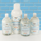 Bio-D fragrance-free shampoo, conditioner, body wash and bubble bath bottles shown together against a blue tiled background, presenting Allergy UK approved, refillable body care for sensitive and allergy-prone skin.