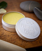 An open tin of Bio-D 100% natural furniture polish available at Babipur. showing the consistency of the polish