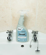 A bottle of Bio-D limescale remover standing on a bathroom sink. This limescale remover is available at Babipur. 