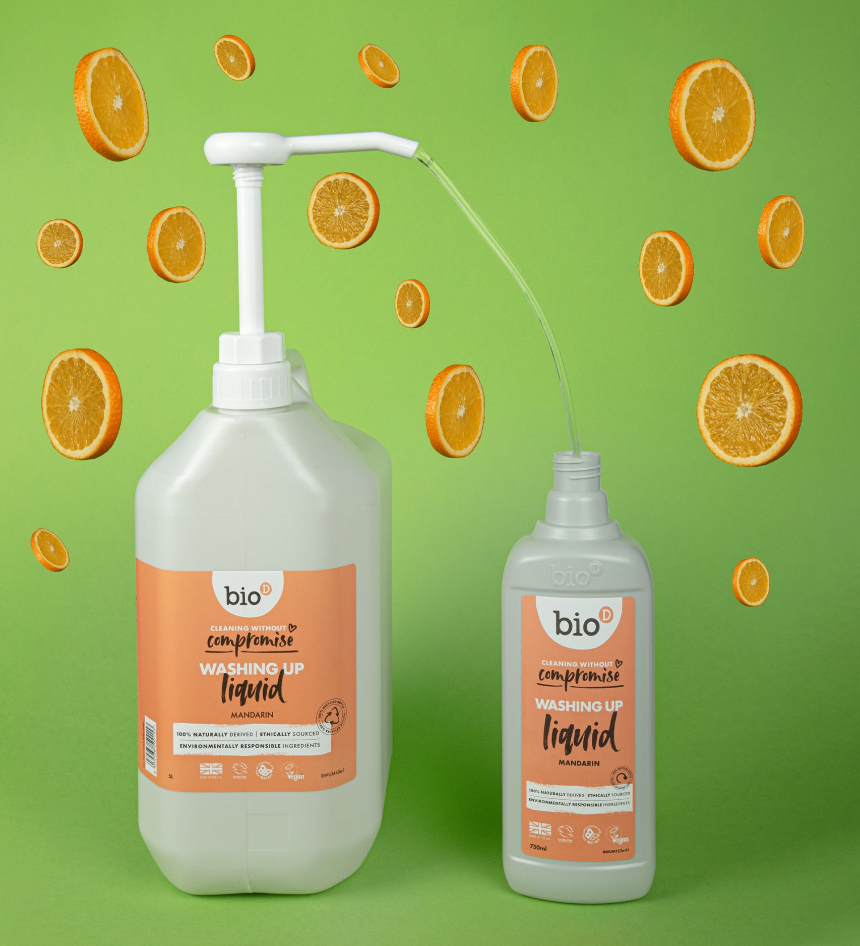 A Bio-D 5L mandarin washing up liquid being poured into a 750ml bottle. Both bottles are available at Babipur 