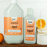 A Bio-D 5Ll mandarin washing up liquid standing next to a  750ml bottle on a wooden surface. Both bottles are available at Babipur 