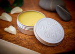 Bio-D open tin of vegan furniture polish with petals and stones