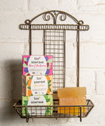 A stack of the 3 different Bio-D soap bars on a fancy metal holder stuck on a wall. These soap bars are available at Babipur