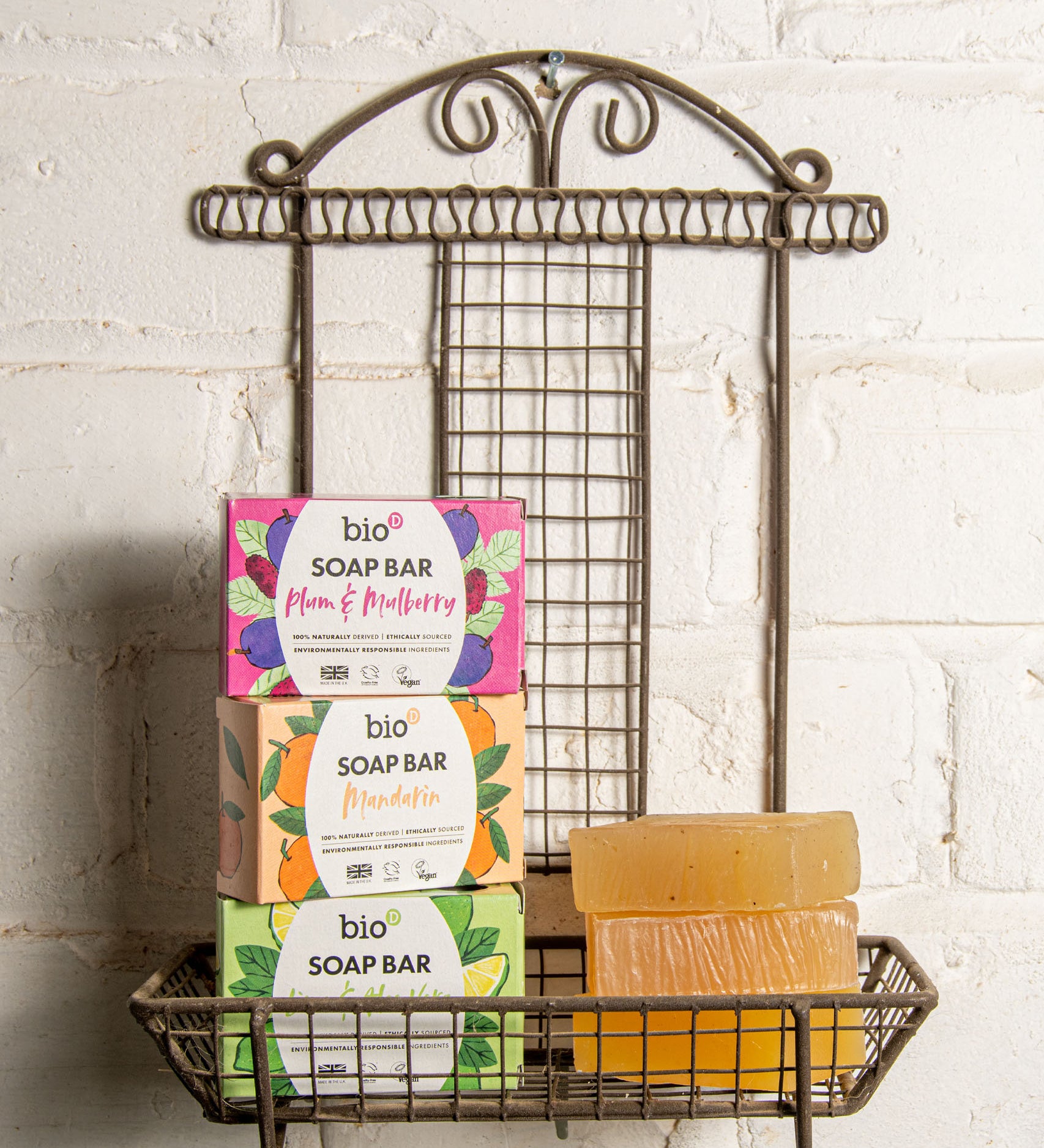 A stack of the 3 different Bio-D soap bars on a fancy metal holder stuck on a wall. These soap bars are available at Babipur