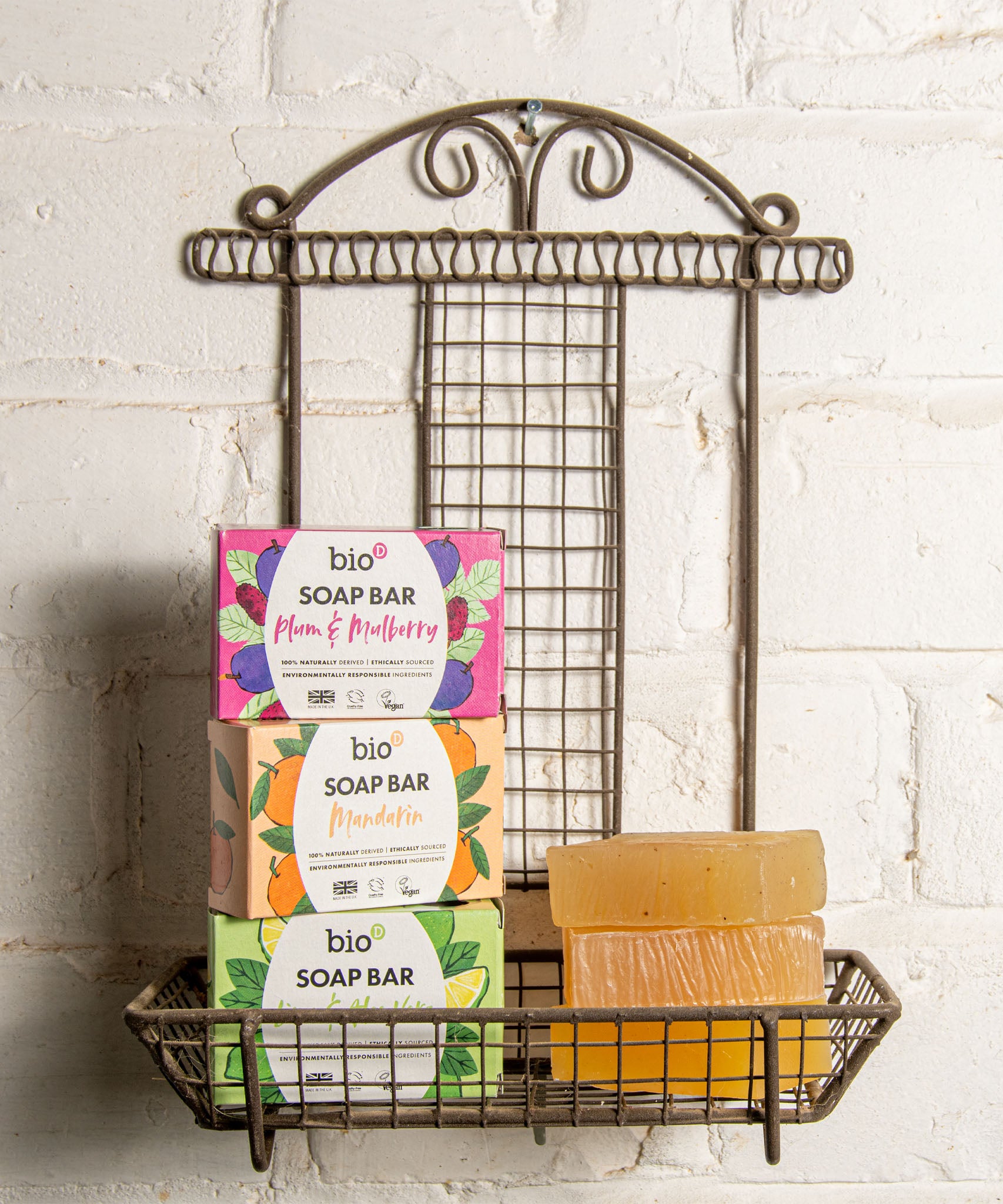 A stack of the 3 different Bio-D soap bars on a fancy metal holder stuck on a wall. These soap bars are available at Babipur