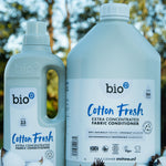A 1 and 5L bottle of Bio-D cotton fresh fabric conditioner standing on a pile of cotton.
