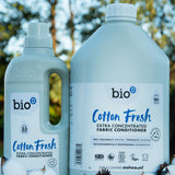 A 1 and 5L bottle of Bio-D cotton fresh fabric conditioner standing on a pile of cotton.