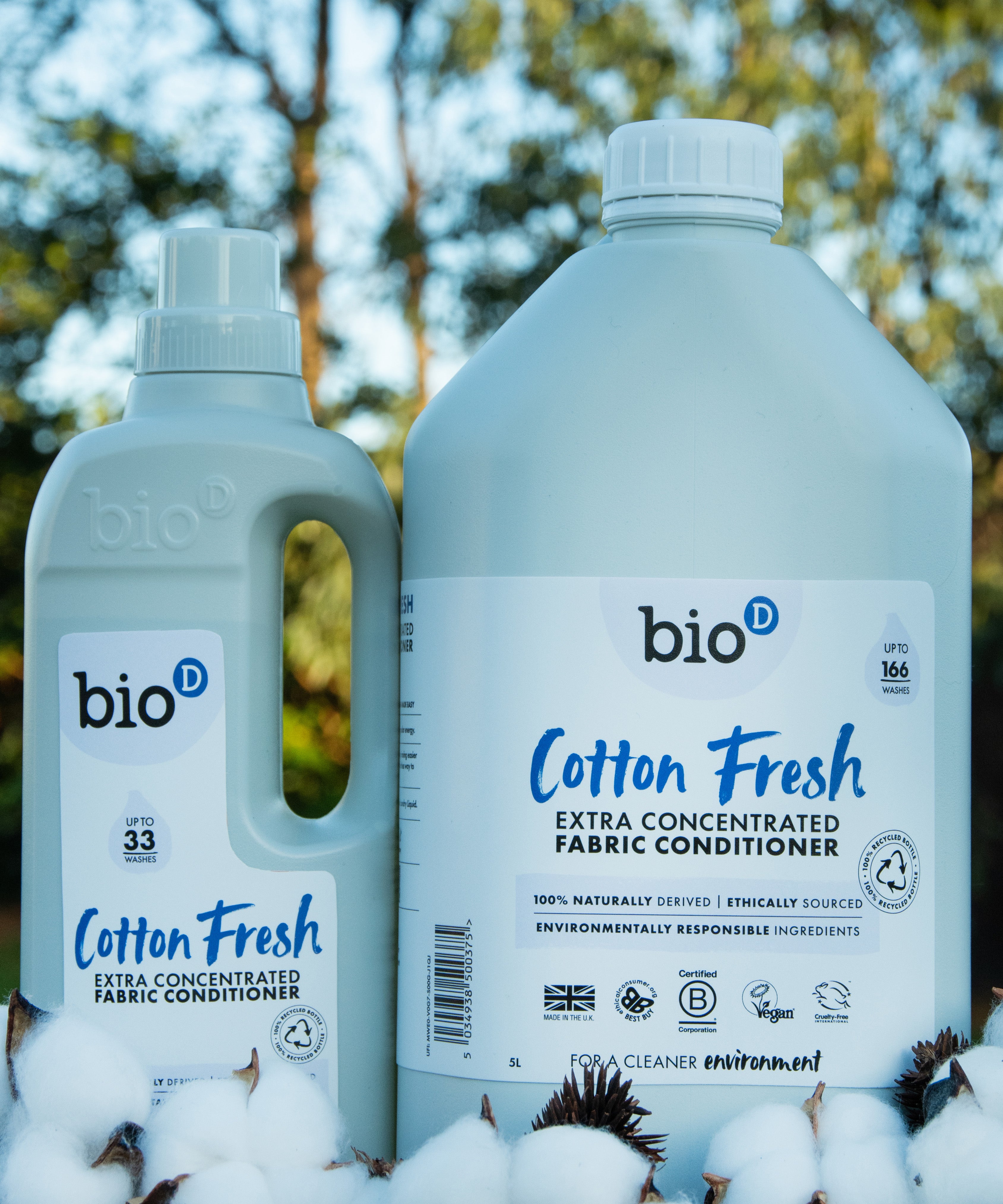 A 1 and 5L bottle of Bio-D cotton fresh fabric conditioner standing on a pile of cotton.