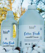 A 1 and 5L bottle of Bio-D cotton fresh laundry liquid and fabric conditioner standing on a pile of cotton.