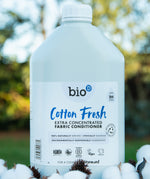 A 5L bottle of Bio-D cotton fresh fabric conditioner standing on a pile of cotton.