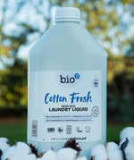 A 5L bottle of Bio-D cotton fresh laundry liquid standing on a pile of cotton.