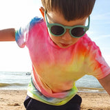 Close up of young boy wearing the Bird flexible childrens sunglasses on a beach
