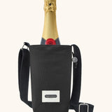 Black + Blum insulated water repellent bottle bag in black with the lid open showing a bottle of champagne sitting inside 