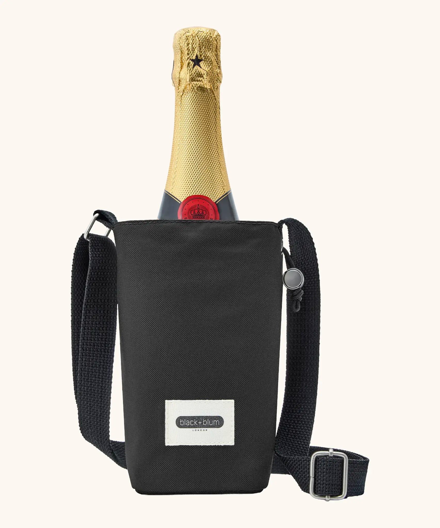 Black + Blum insulated water repellent bottle bag in black with the lid open showing a bottle of champagne sitting inside 