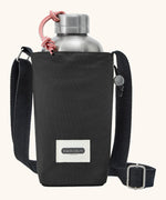 Black + Blum insulated water repellent bottle bag in black with the lid open showing a flask sitting inside 