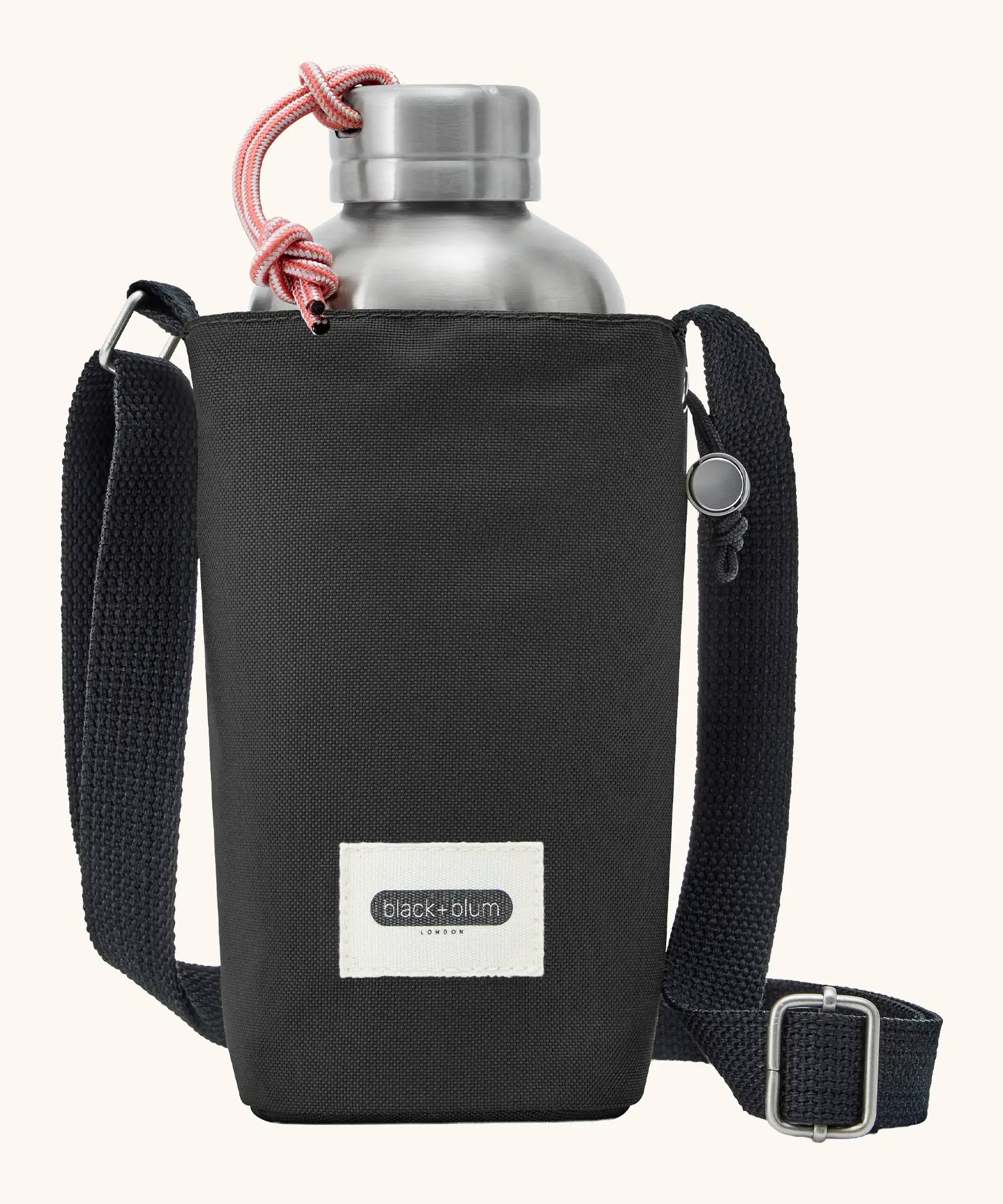 Black + Blum insulated water repellent bottle bag in black with the lid open showing a flask sitting inside 
