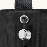 Black + Blum insulated bottle bag in black showing a close up of the adjustable drawstring for holding bottles