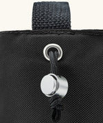 Black + Blum insulated bottle bag in black showing a close up of the adjustable drawstring for holding bottles